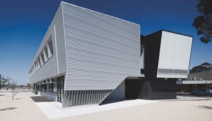 Steel plays a starring role at the entry to each SWIS, were a two-storey-high inverted L-shaped canopy is clad in Stramit Longspan® made from COLORBOND® steel that touches the ground